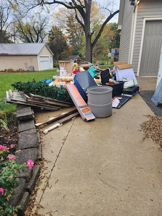 Dumpster being loaded with debris for Roofing Dumpster Rental in Lolo